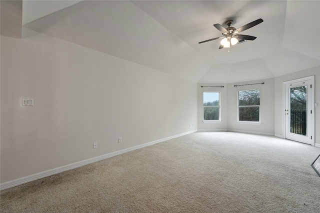 carpeted empty room featuring vaulted ceiling and ceiling fan