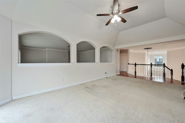 spare room featuring ceiling fan, carpet flooring, and vaulted ceiling