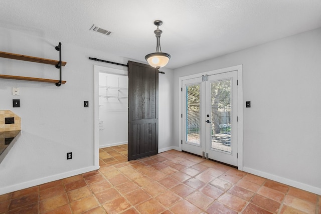 interior space featuring french doors and a textured ceiling