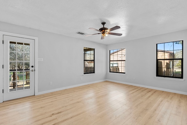 spare room featuring ceiling fan, a textured ceiling, and light hardwood / wood-style flooring