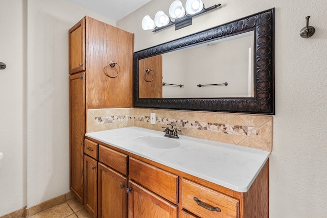 bathroom featuring tile patterned floors, vanity, and backsplash