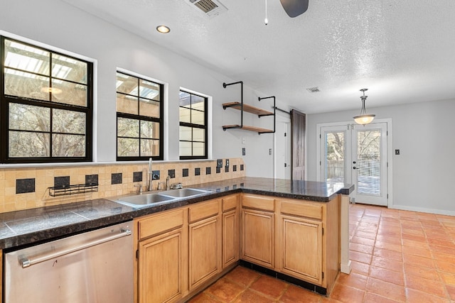 kitchen featuring sink, dishwasher, french doors, decorative backsplash, and kitchen peninsula