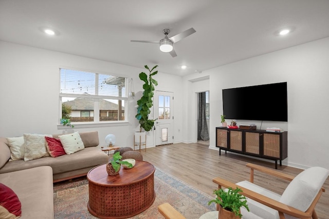 living room featuring hardwood / wood-style flooring and ceiling fan