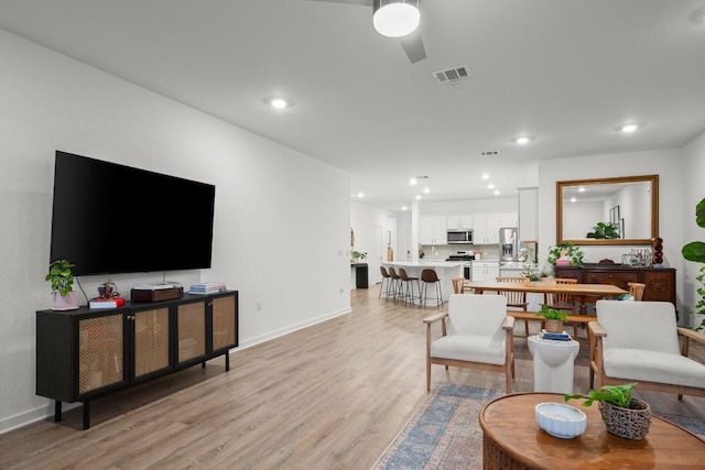 living room with light hardwood / wood-style flooring