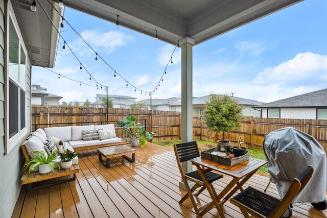 deck with outdoor lounge area and a grill