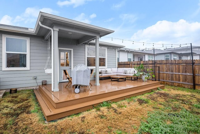 back of property with an outdoor hangout area, a deck, and a lawn