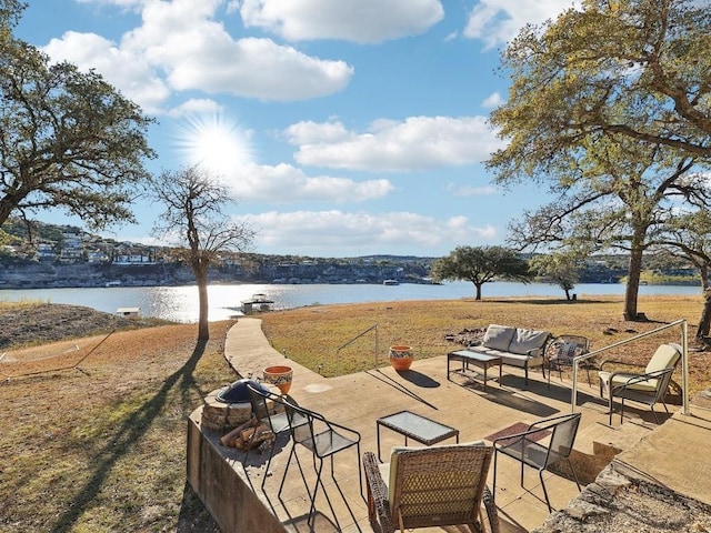 view of patio featuring an outdoor living space and a water view