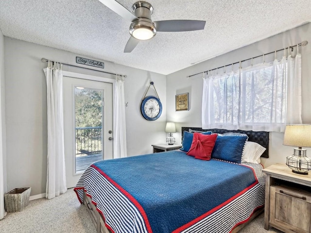 bedroom with ceiling fan, light carpet, access to outside, and a textured ceiling