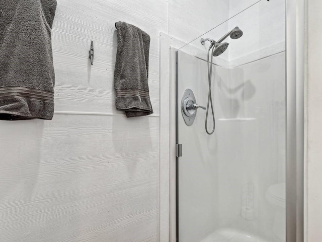 bathroom with a shower with door