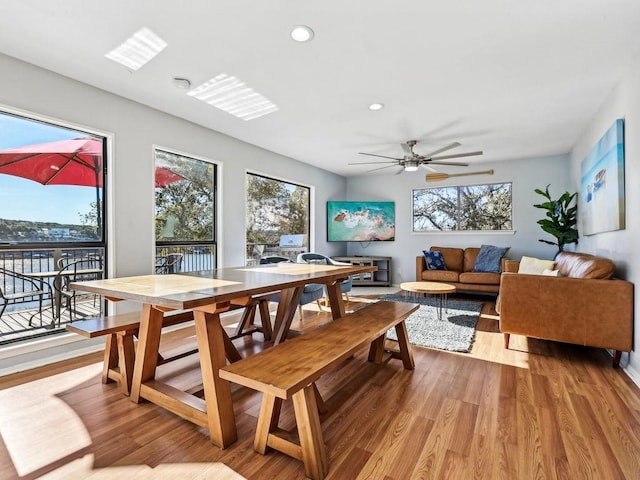 dining room with ceiling fan and light hardwood / wood-style floors