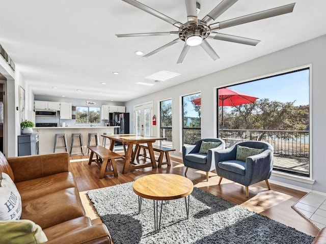 living room featuring wood-type flooring and ceiling fan