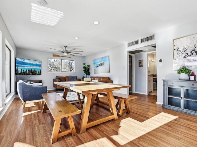 dining room with ceiling fan and light wood-type flooring