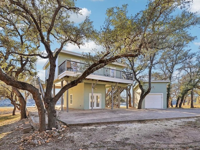 view of front facade with a wooden deck and a garage