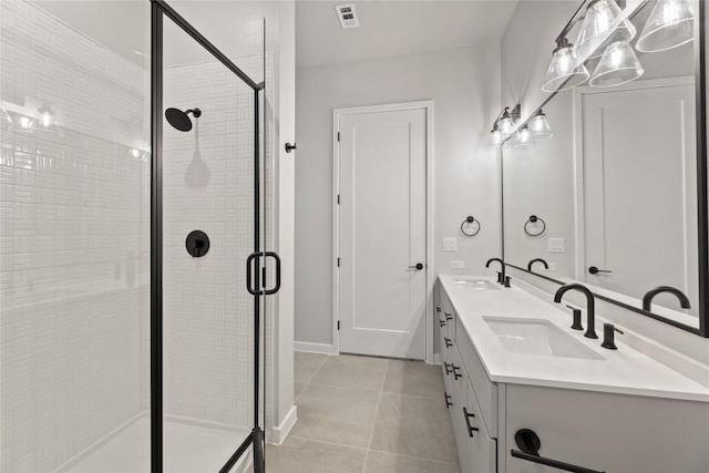 bathroom featuring tile patterned floors, vanity, and a shower with door