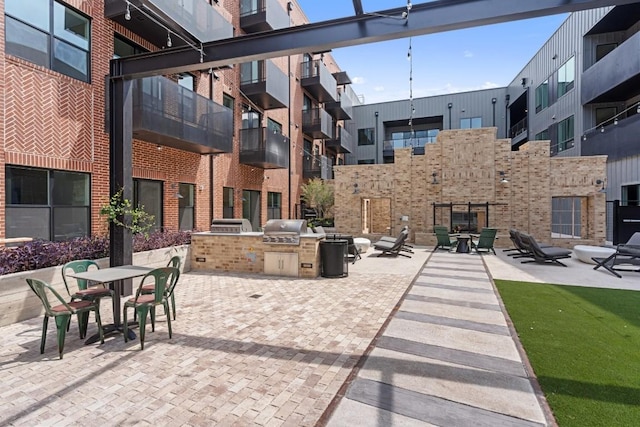 view of patio with area for grilling and a grill