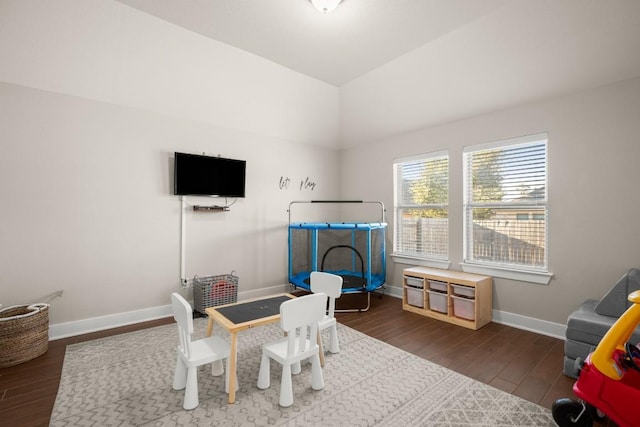 playroom featuring dark hardwood / wood-style flooring and vaulted ceiling