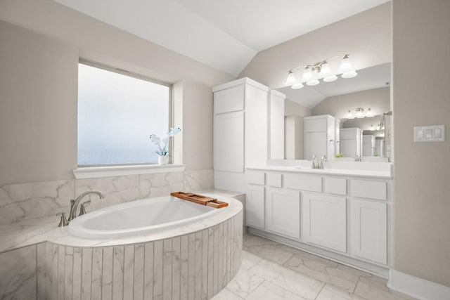 120 Red Granite Rd, Georgetown, TX 78633 - bathroom featuring marble finish flooring, lofted ceiling, a garden tub, and vanity