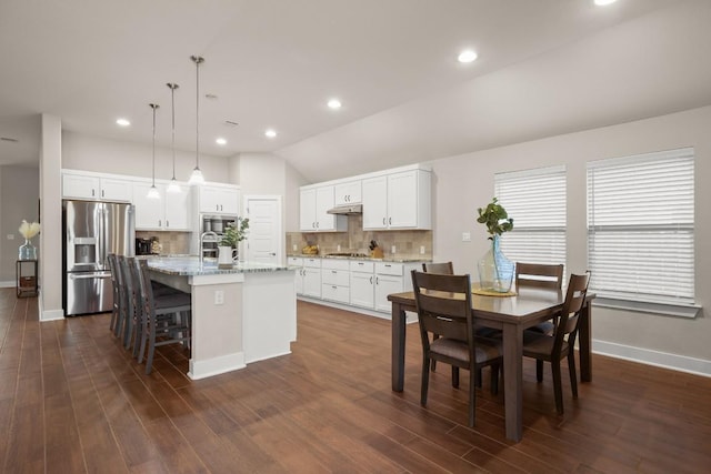 120 Red Granite Rd, Georgetown, TX 78633 - dining space with baseboards, vaulted ceiling, dark wood-style floors, and recessed lighting
