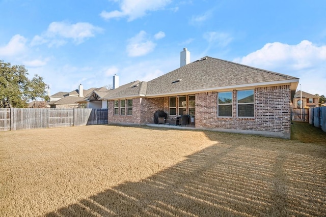 120 Red Granite Rd, Georgetown, TX 78633 - rear view of property with brick siding, roof with shingles, a chimney, and a patio area