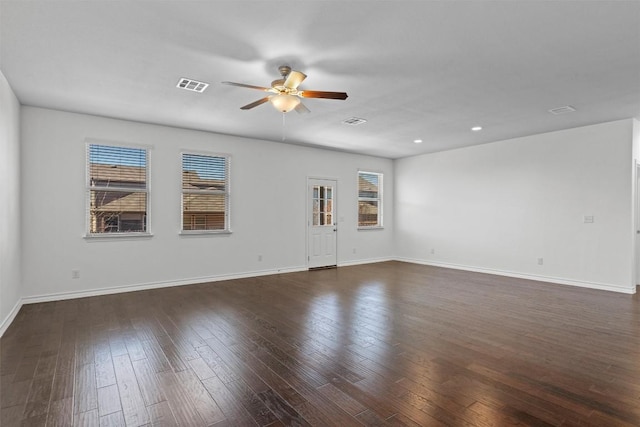 empty room with ceiling fan and dark hardwood / wood-style flooring