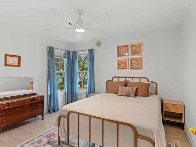 bedroom with ceiling fan and light wood-type flooring