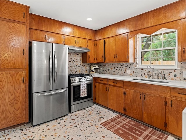 kitchen with tasteful backsplash, sink, and appliances with stainless steel finishes