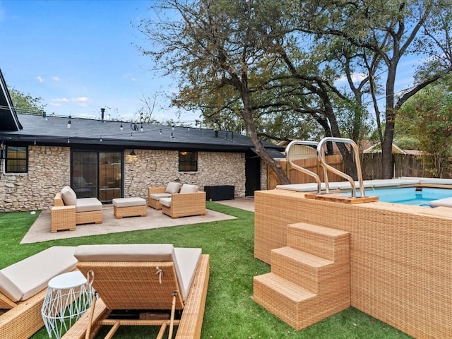 exterior space featuring an outdoor living space, a patio area, and a lawn