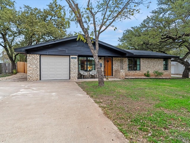 view of front of home featuring a garage and a front lawn