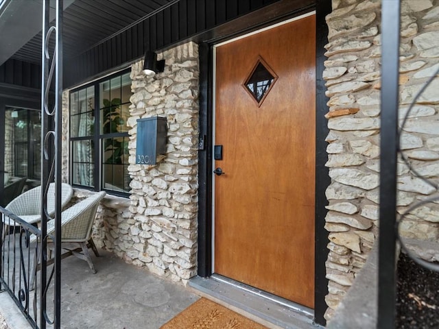 view of exterior entry with a porch