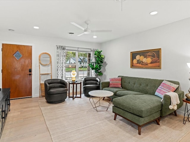 living room featuring light hardwood / wood-style floors and ceiling fan