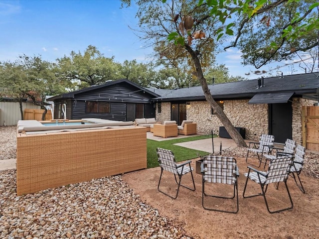 back of property featuring outdoor lounge area and a patio area