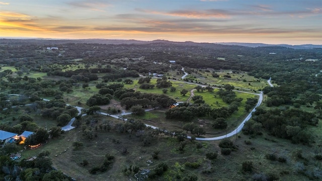 aerial view at dusk featuring a mountain view