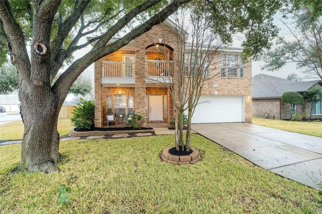 view of front of property with a garage, a front yard, and a balcony