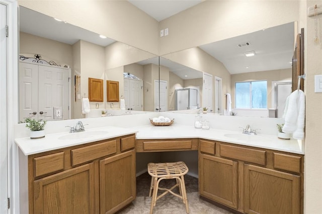 bathroom featuring vanity, vaulted ceiling, and walk in shower