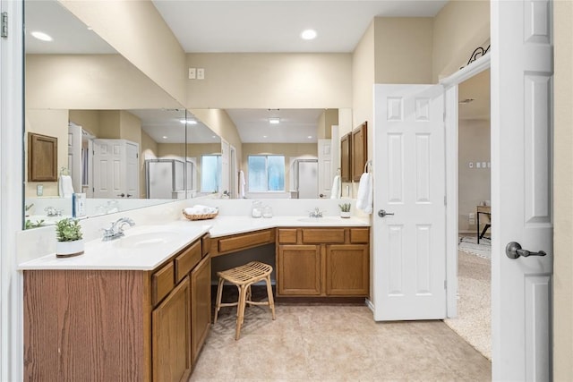 bathroom with vanity and a shower with shower door