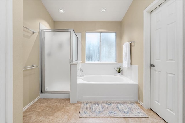 bathroom featuring tile patterned floors and shower with separate bathtub