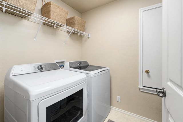 laundry area with independent washer and dryer