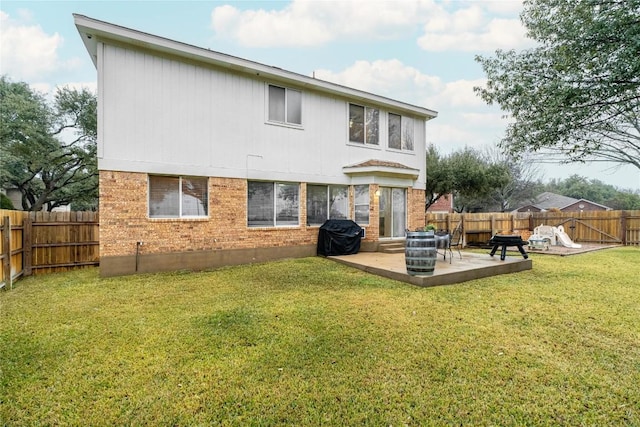 back of house with a yard and a patio