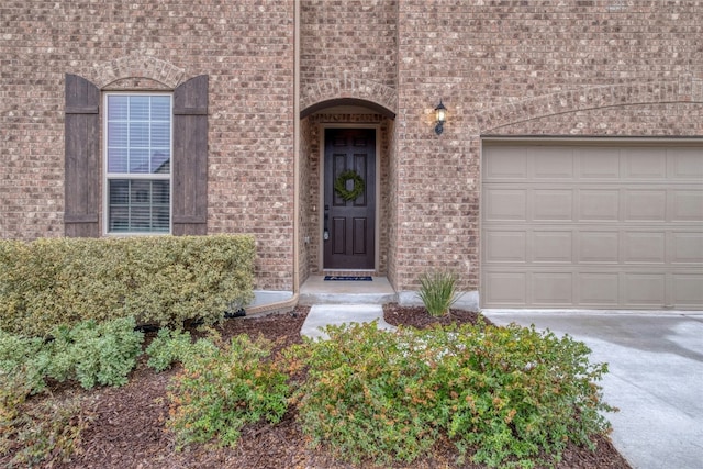 doorway to property with a garage