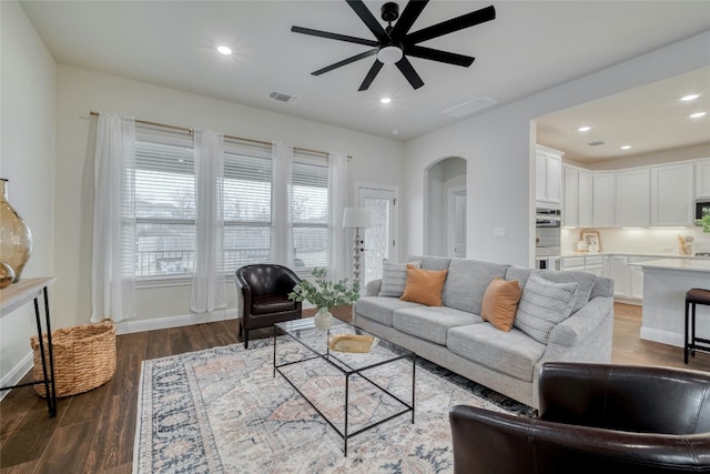 living room featuring wood-type flooring and ceiling fan