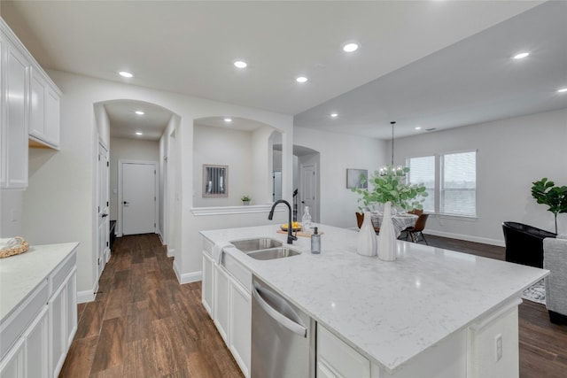 kitchen featuring dark hardwood / wood-style floors, an island with sink, dishwasher, sink, and white cabinets