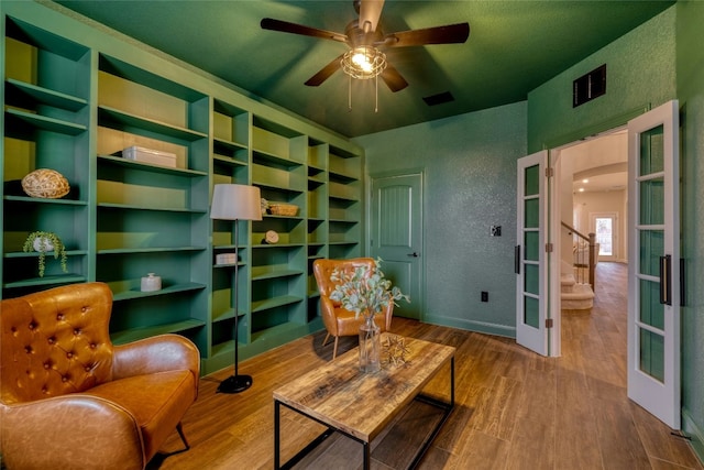 sitting room featuring french doors, ceiling fan, and hardwood / wood-style flooring