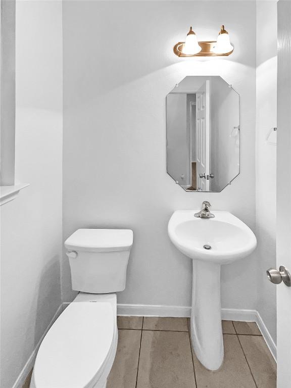 bathroom featuring tile patterned flooring and toilet