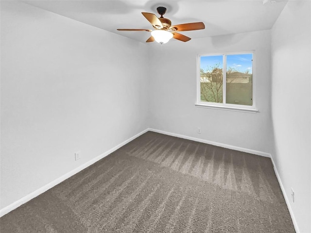 unfurnished room featuring ceiling fan and dark colored carpet