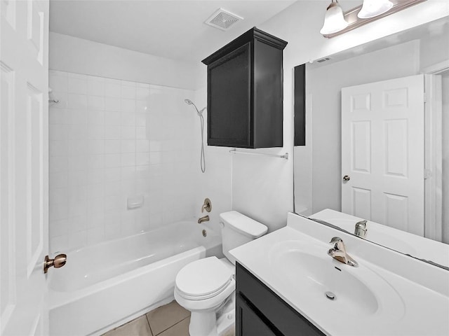 full bathroom featuring tile patterned floors, toilet, tiled shower / bath combo, and vanity