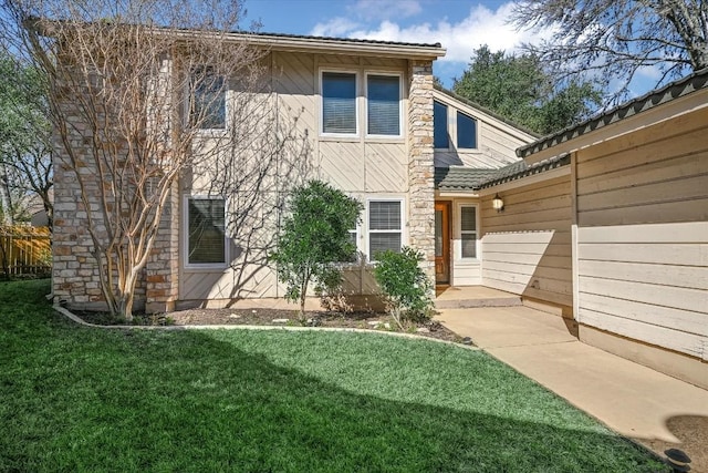 rear view of property featuring a yard and a patio area