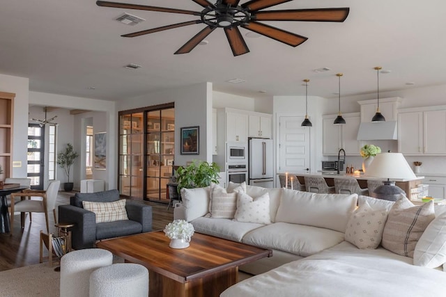 living room with hardwood / wood-style flooring and ceiling fan