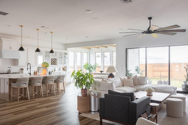 living room with ceiling fan and dark hardwood / wood-style floors