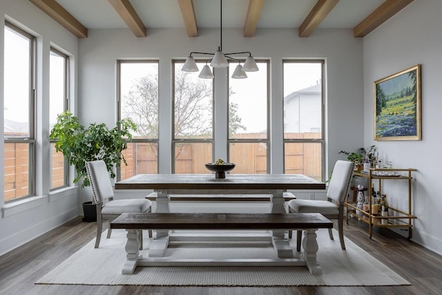 dining space with hardwood / wood-style flooring and beamed ceiling