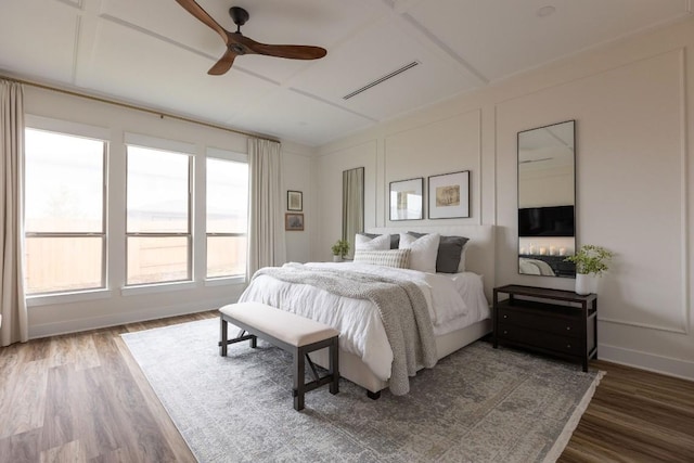 bedroom featuring dark wood-type flooring, ceiling fan, and vaulted ceiling